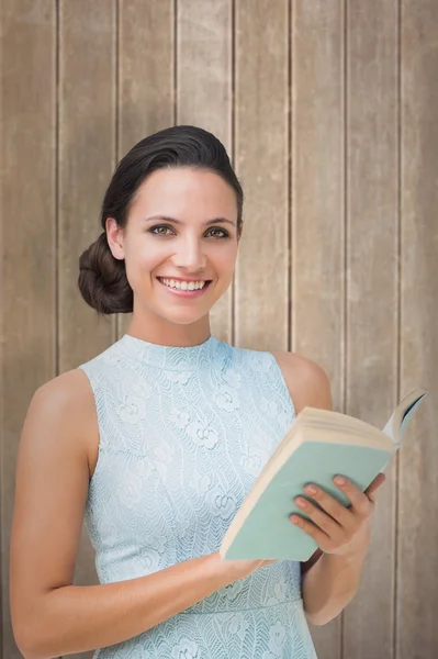 Stylish brunette against wooden surface — Stock Photo, Image