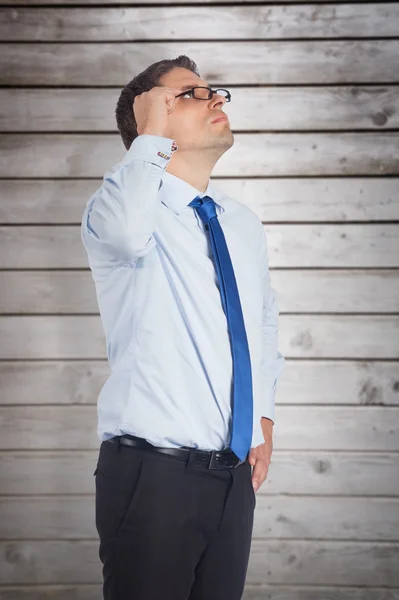 Thinking businessman tilting glasses — Stock Photo, Image