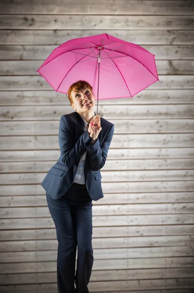 Geschäftsfrau mit Regenschirm gegen Holzplanken — Stockfoto