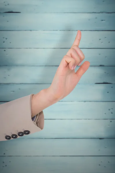 Businesswoman pointing against wooden planks — Stock Photo, Image