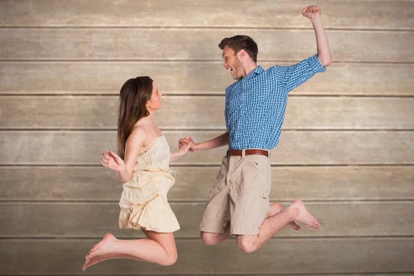 Cheerful young couple jumping — Stock Photo, Image