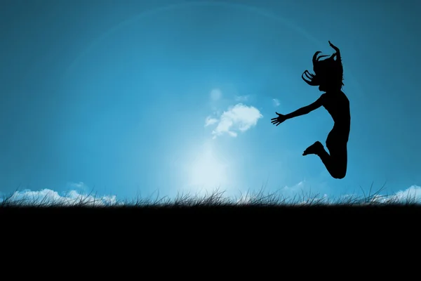 Woman jumping against blue sky — Stock Photo, Image