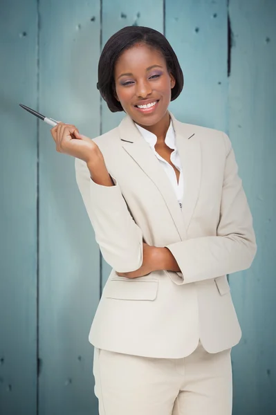 Thinking businesswoman against wooden planks — Stock Photo, Image