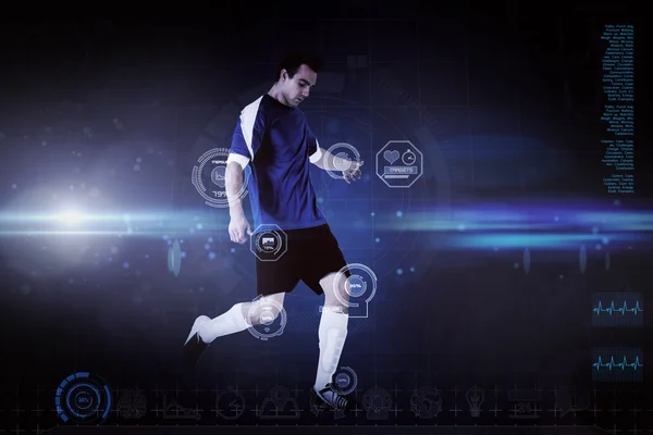 Composite image of football player in blue kicking — Stock Photo, Image