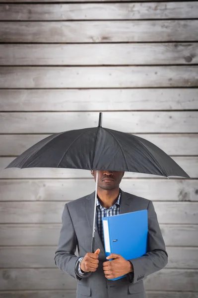 Businessman standing under umbrella — Stock Photo, Image