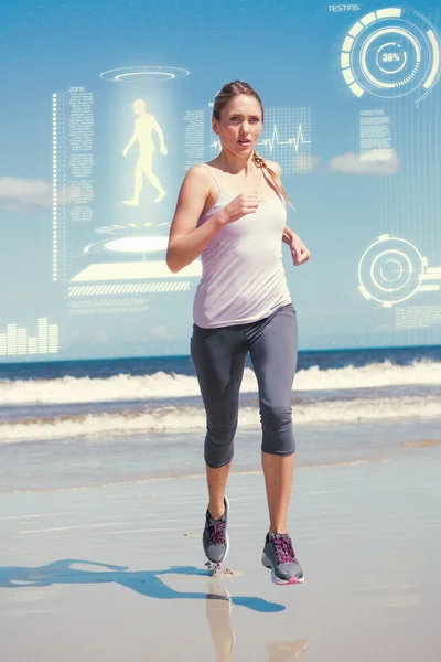 Focused fit bionda jogging sulla spiaggia — Foto Stock