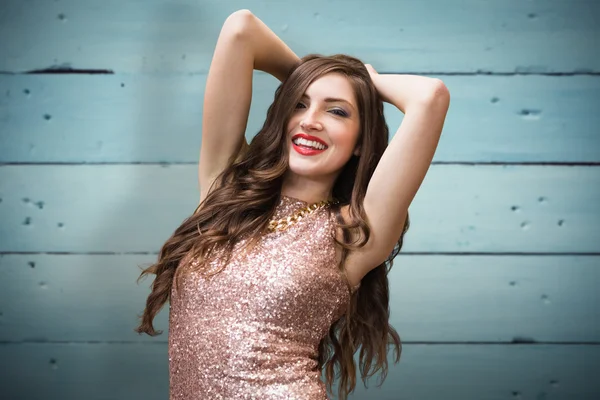 Glamorous brunette against wooden planks — Stock Photo, Image