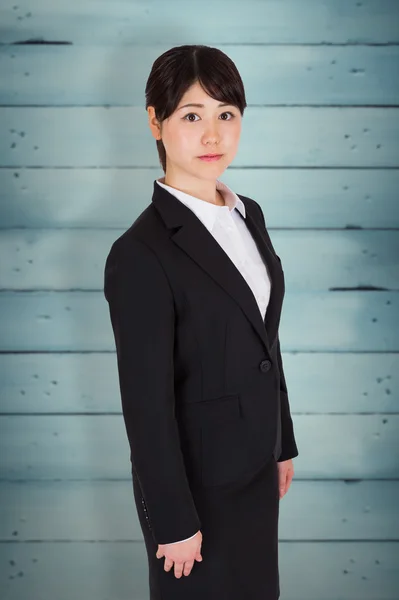 Serious businesswoman against wooden planks — Stock Photo, Image