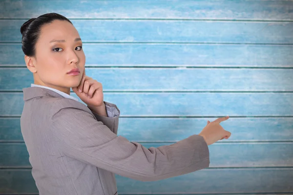 Pensativo asiático mujer de negocios señalando —  Fotos de Stock