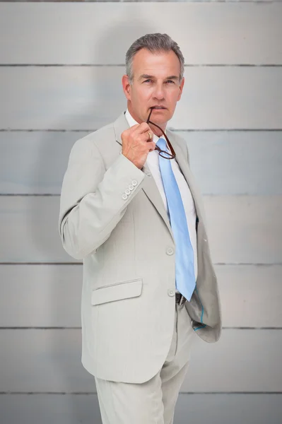 Thinking businessman against wooden planks — Stock Photo, Image