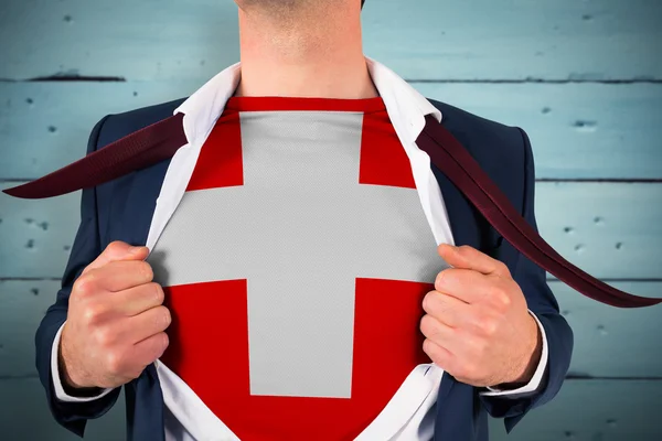 Businessman opening shirt to reveal swiss flag — Stock Photo, Image