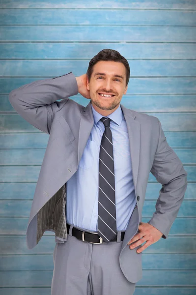 Thinking businessman against wooden planks — Stock Photo, Image