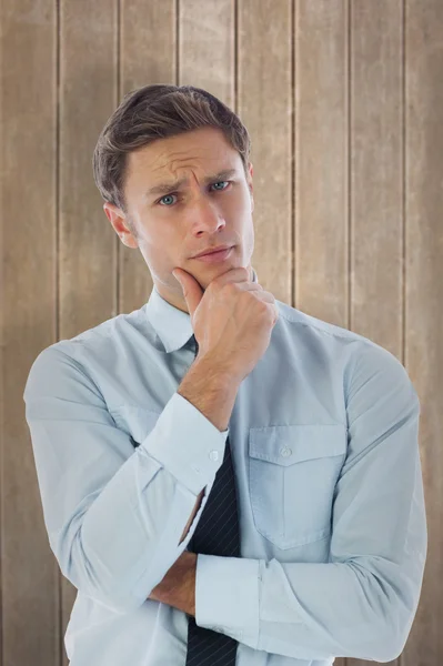 Thinking businessman with hand on chin — Stock Photo, Image