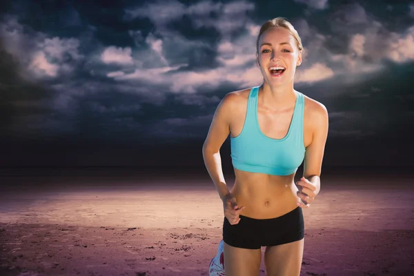 Fit woman smiling and jogging — Stock Photo, Image