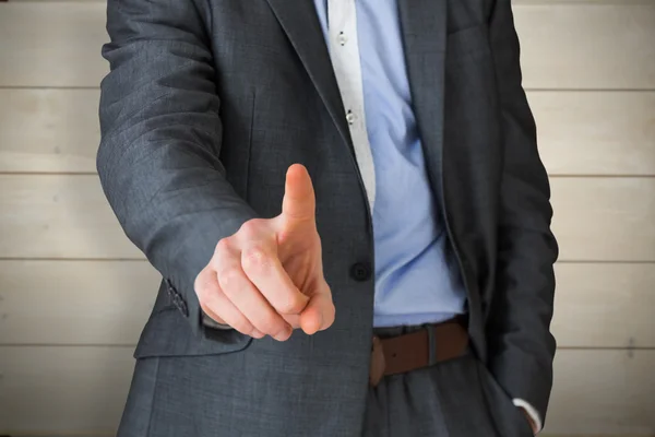 Businessman in grey suit pointing — Stock Photo, Image