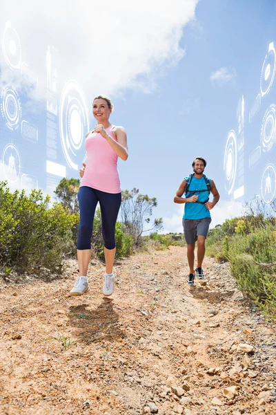 Fit couple jogging down mountain trail — Stock Photo, Image