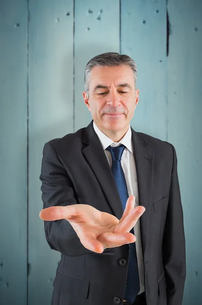 Mature businessman holding his hands out — Stock Photo, Image