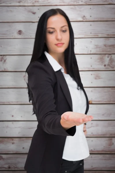 Pretty businesswoman presenting with hand — Stock Photo, Image