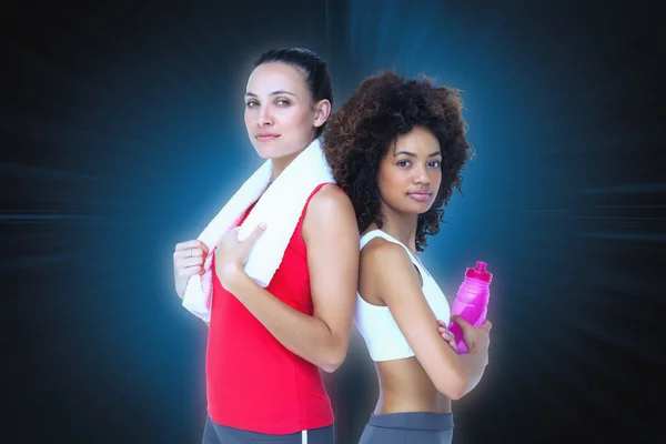 Fit women standing with waterbottle and towel — Stock Photo, Image