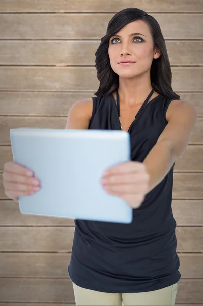Model holding tablet looking up — Stock Photo, Image