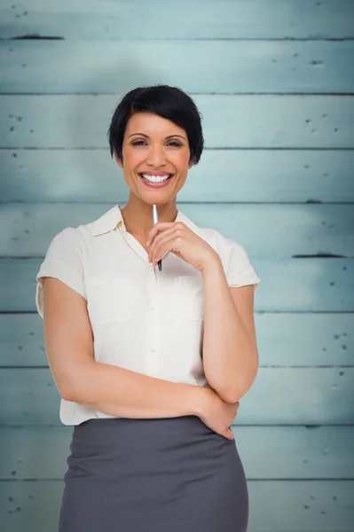 Thoughtful businesswoman against wooden planks — Stock Photo, Image