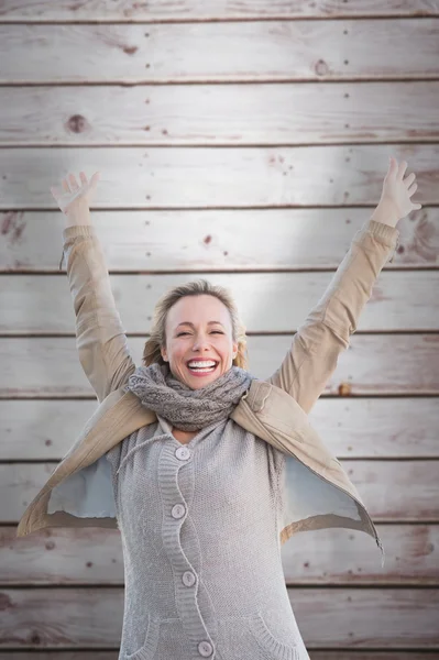 Cheering blonde against wooden planks — Stock Photo, Image