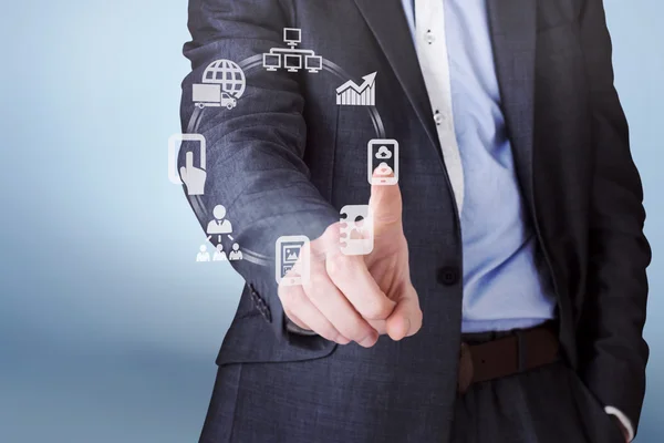 Businessman in grey suit pointing — Stock Photo, Image