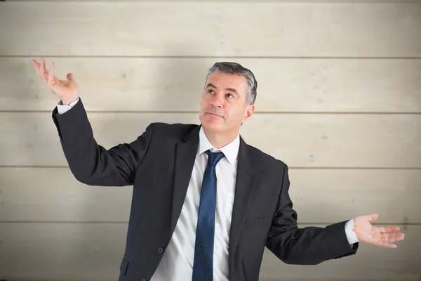Mature businessman holding hands out — Stock Photo, Image