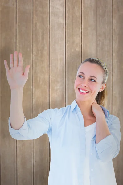 Blonde woman with hand raised — Stock Photo, Image