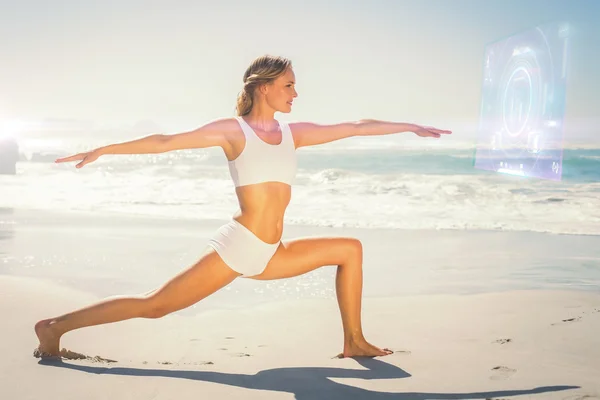 Gorgeous blonde in warrior pose by sea — Stock Photo, Image