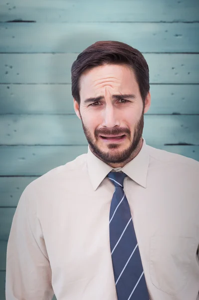 Sad businessman against wooden planks — Stock Photo, Image