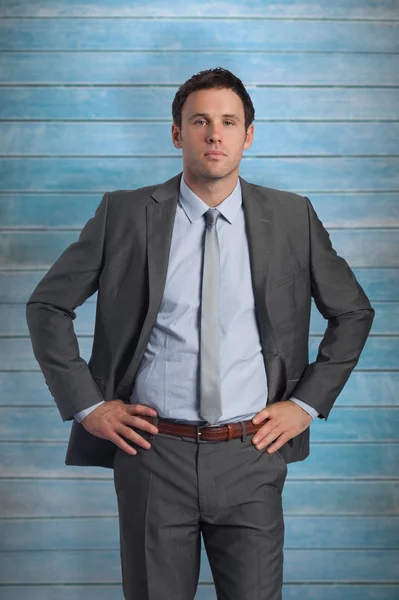 Serious businessman with hands on hips — Stock Photo, Image
