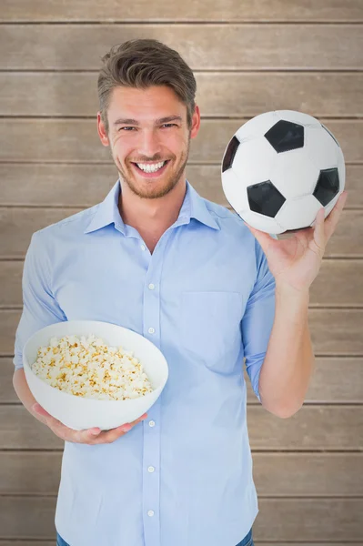 Man holding ball and popcorn — Stock Photo, Image