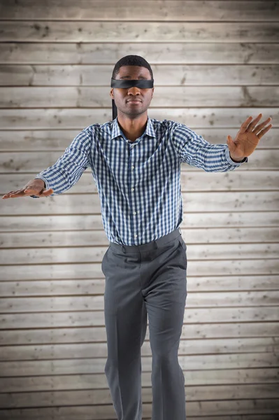 Blindfolded businessman with arms out — Stock Photo, Image