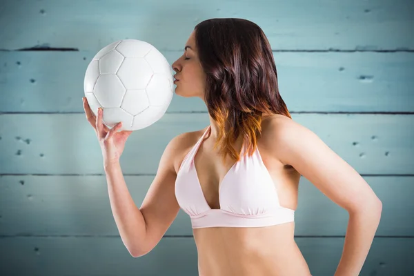 Brunette in bikini kiss football — Stok Foto