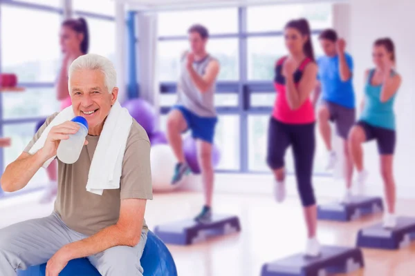 Senior man drinking from water bottle — Stock Photo, Image