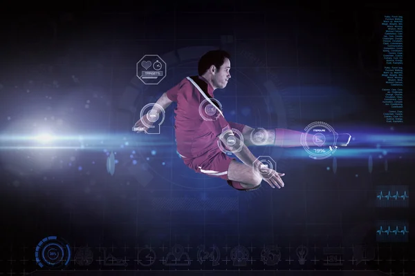 Composite image of football player in red kicking — Stock Photo, Image