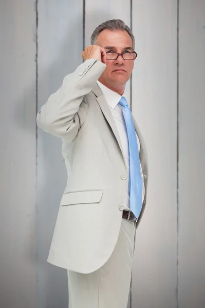 Thinking businessman against wooden planks — Stock Photo, Image