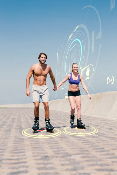 Fit couple rollerblading together on promenade — Stock Photo, Image