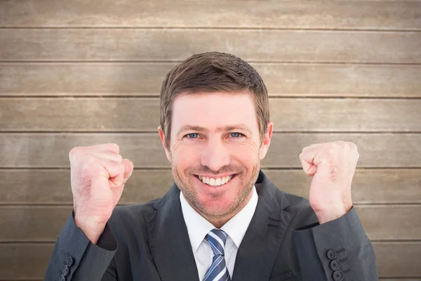 Businessman smiling and cheering — Stock Photo, Image