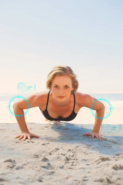 Fit blonde in plank position on the beach — Stock Photo, Image