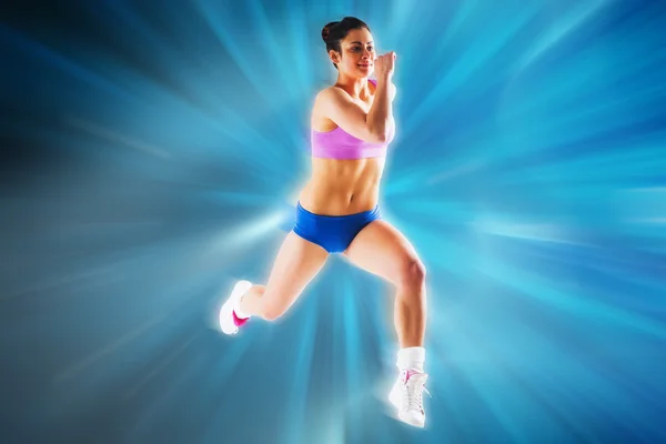 Fit brunette running and jumping — Stock Photo, Image