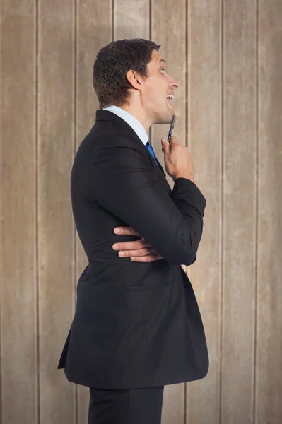 Thinking businessman holding pen — Stock Photo, Image