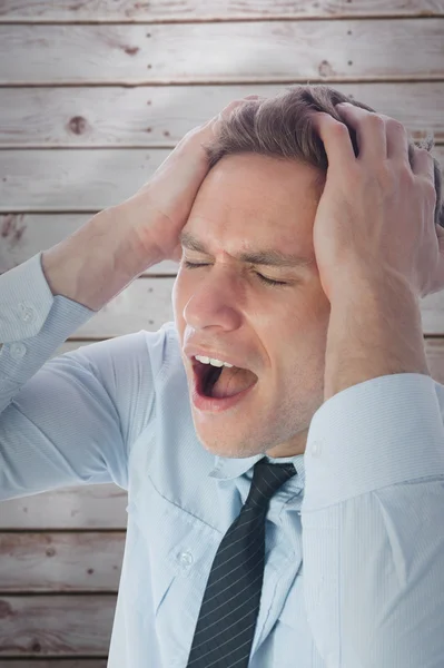 Stressed businessman with hands on head — Stock Photo, Image