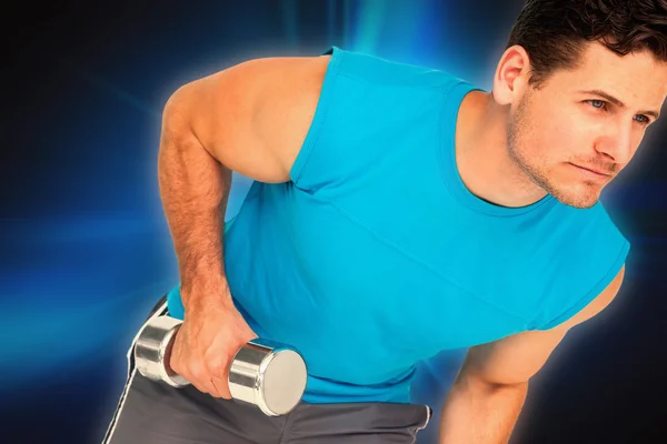 Fit young man exercising with dumbbell — Stock Photo, Image