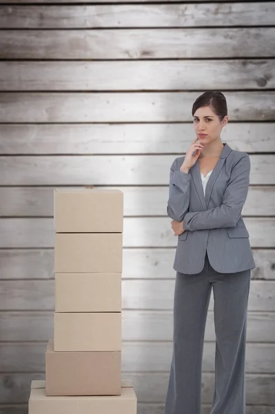 Businesswoman posing with cardboard boxes — Stock Photo, Image