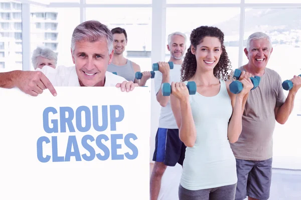 Man showing a poster against group classes — Stock Photo, Image