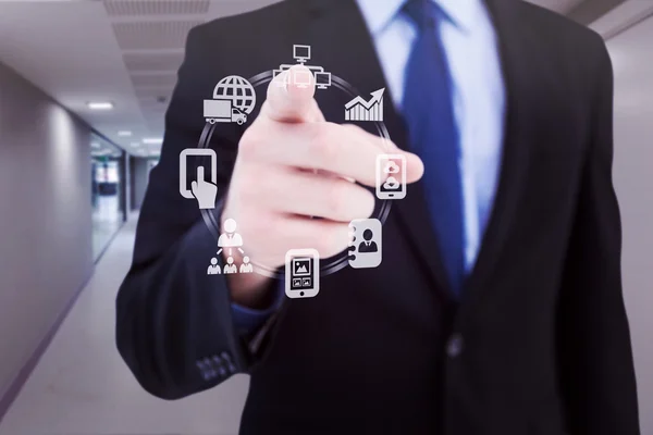 Composite image of businessman pointing his finger at camera — Stock Photo, Image