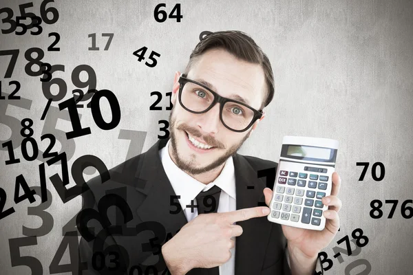 Geeky businessman pointing to calculator — Stock Photo, Image