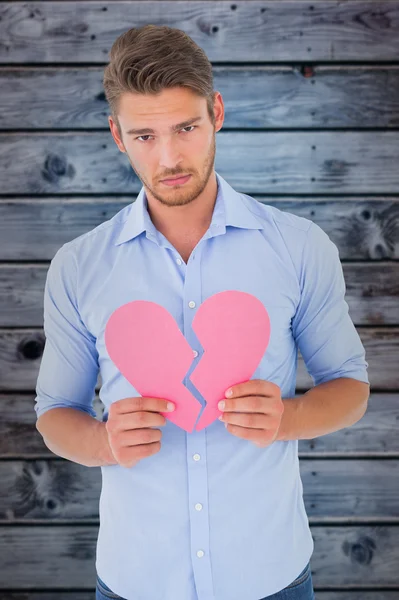 Sad man holding a broken heart — Stock Photo, Image